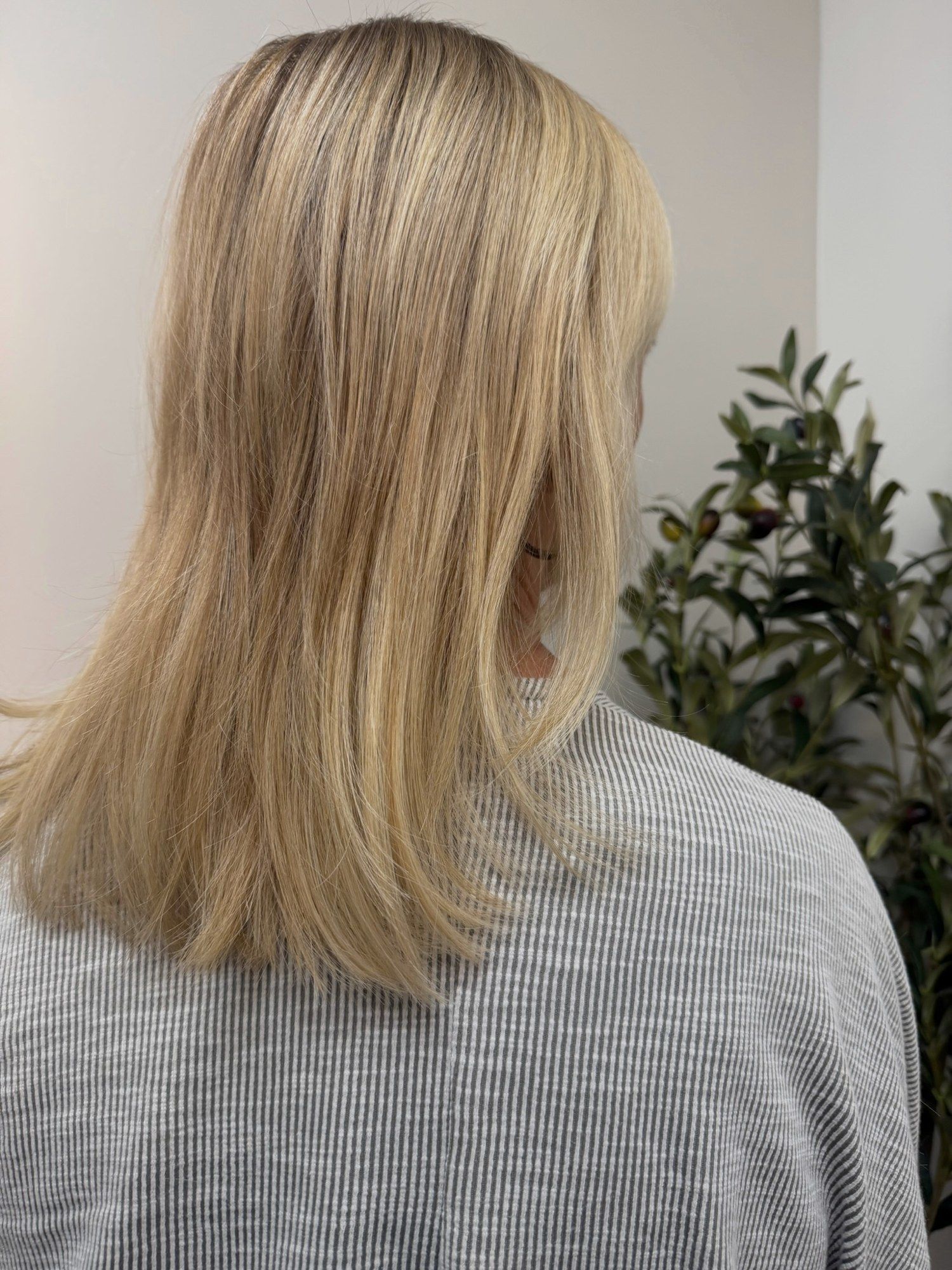 After: the same client with fuller blonde hair after custom K-tips