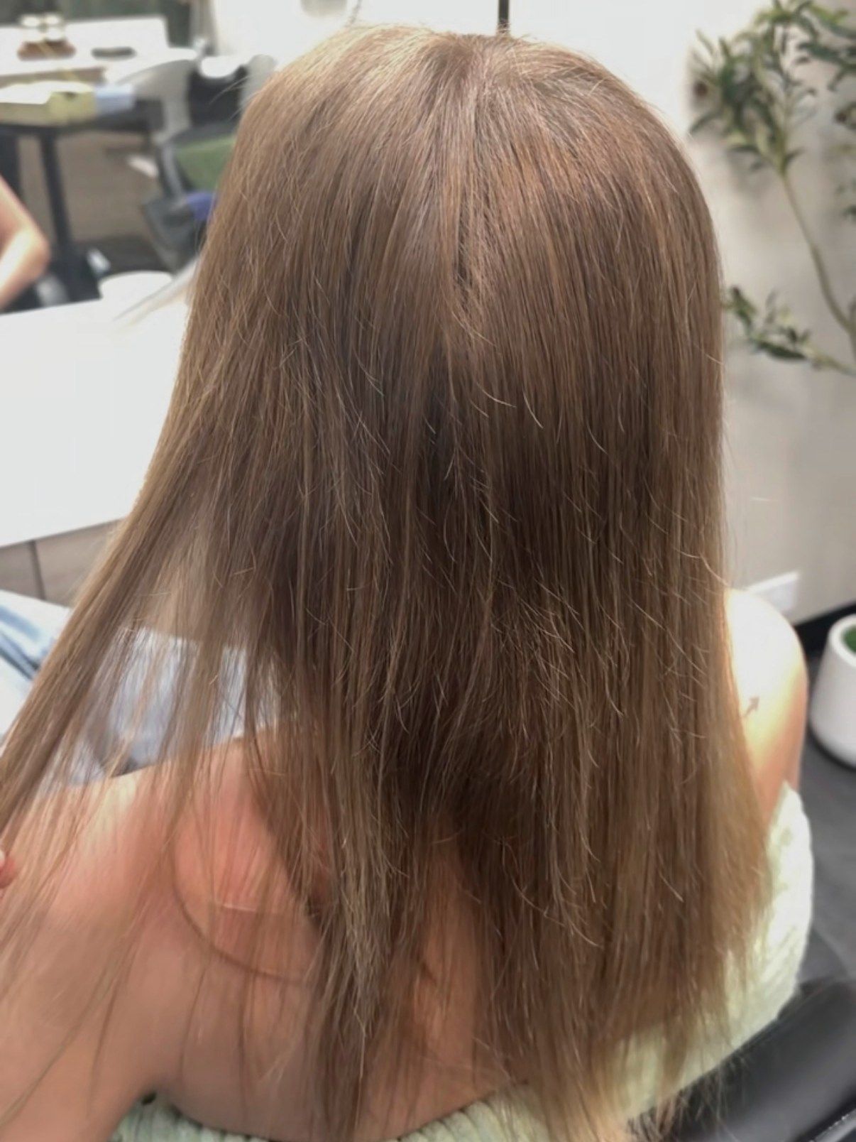 Before: straight, fine light-brown hair from behind, seated in the studio