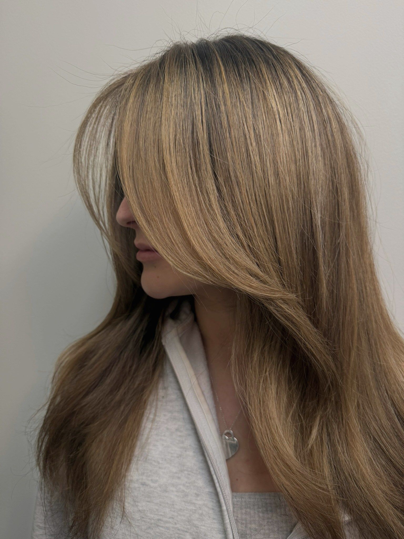 Golden brown lived-in color with long layers, from the side