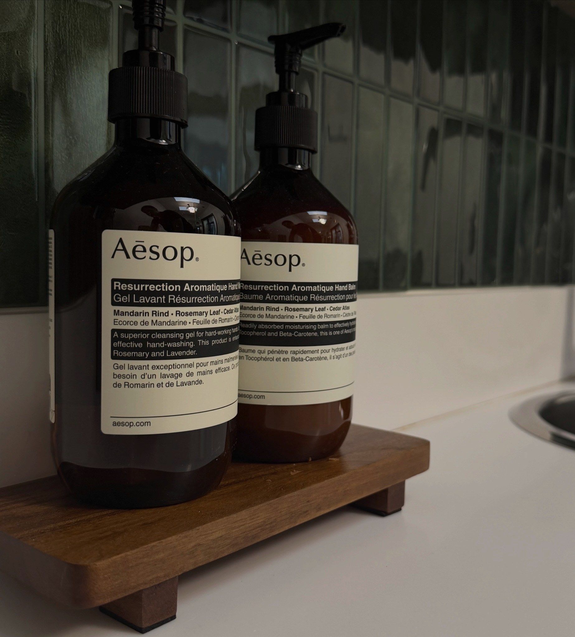 Aesop bottles on a wooden tray at the studio sink