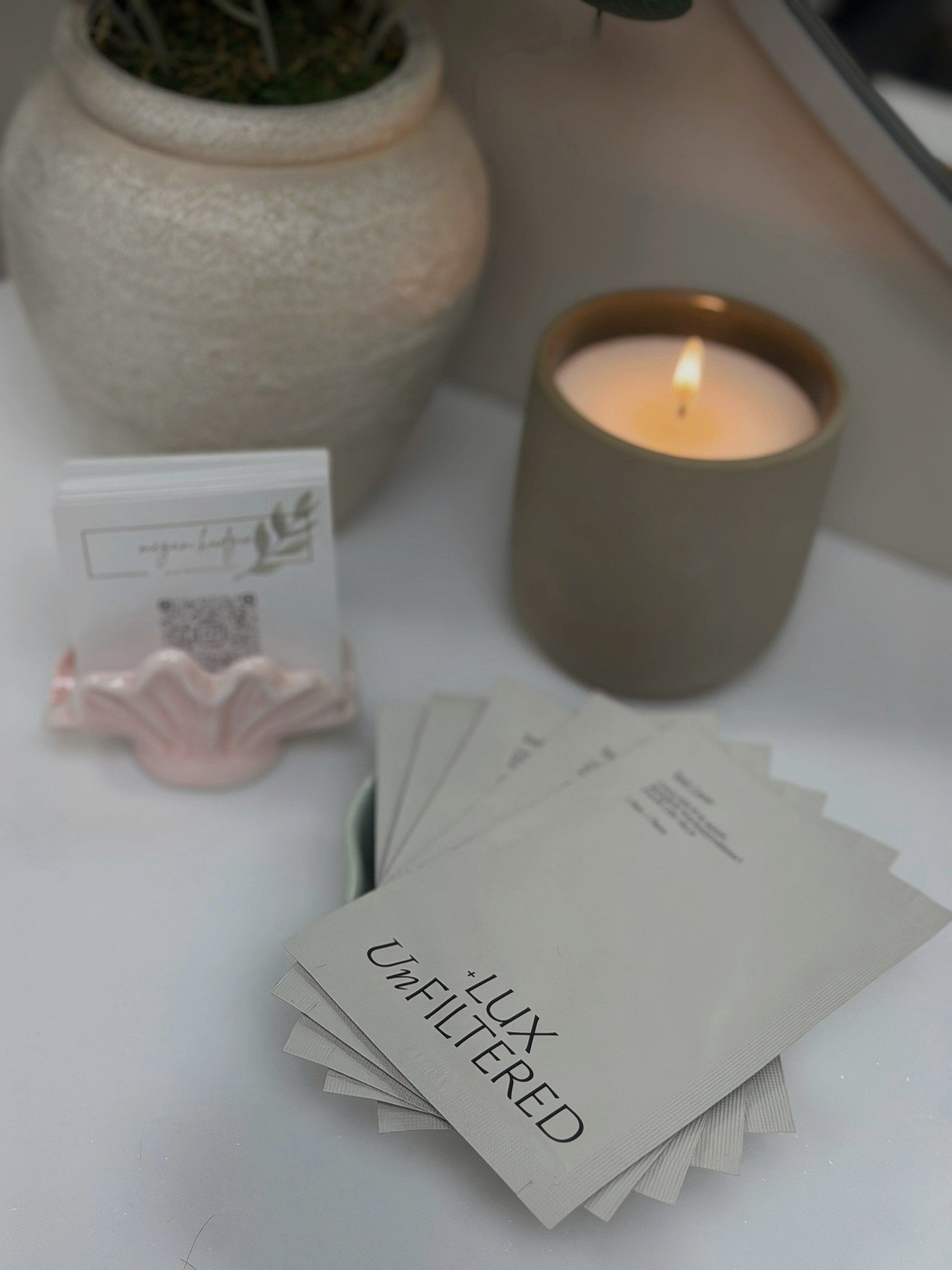 A candle on the counter in Megan’s suite